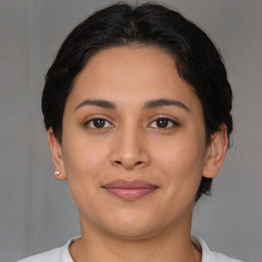 Joyful latino young-adult female with short  brown hair and brown eyes