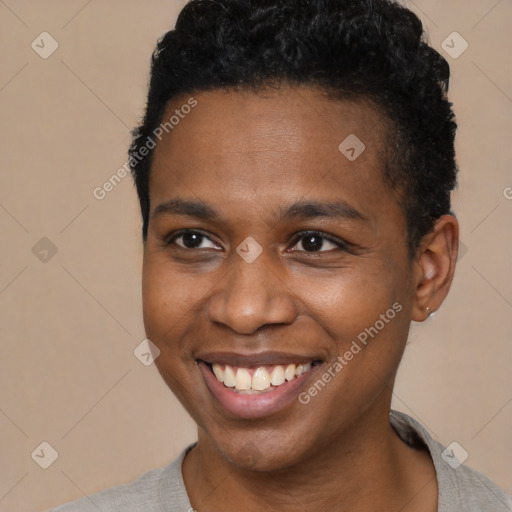 Joyful black young-adult male with short  brown hair and brown eyes