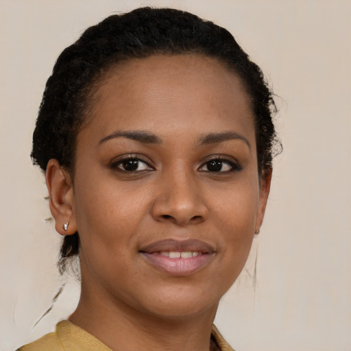 Joyful black young-adult female with short  brown hair and brown eyes