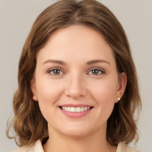 Joyful white young-adult female with medium  brown hair and green eyes