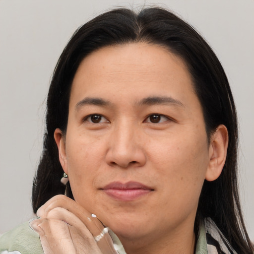 Joyful asian adult male with medium  brown hair and brown eyes