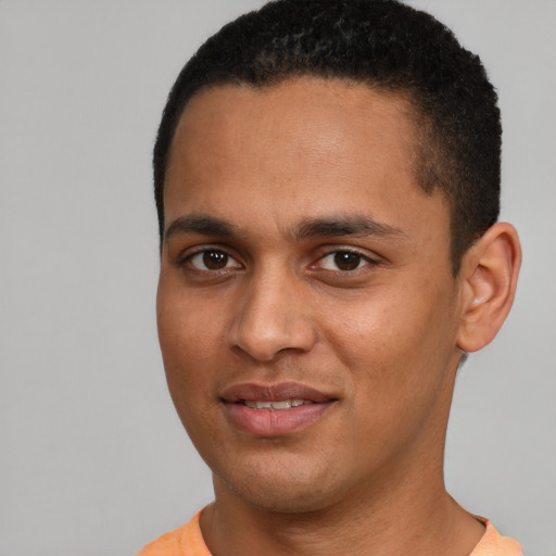 Joyful black young-adult male with short  brown hair and brown eyes
