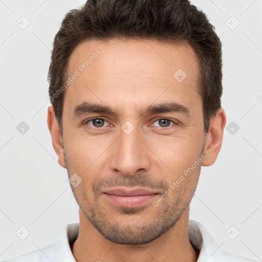 Joyful white young-adult male with short  brown hair and brown eyes