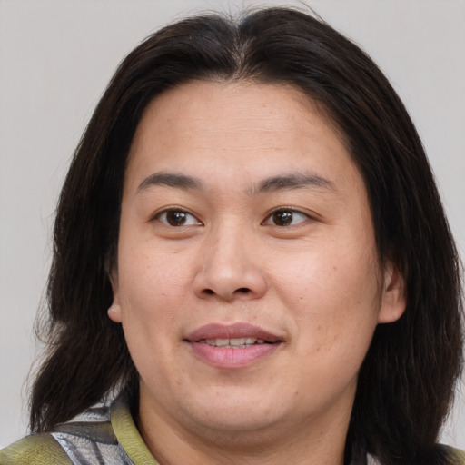 Joyful white adult female with medium  brown hair and brown eyes