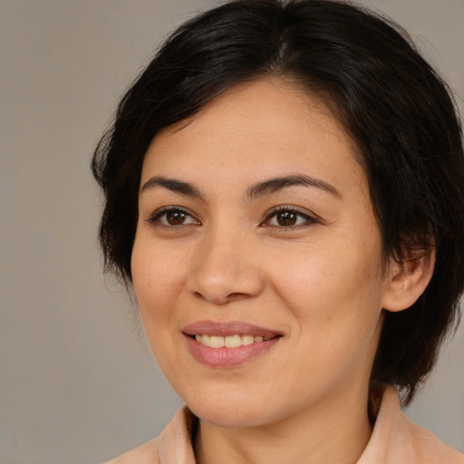 Joyful asian young-adult female with medium  brown hair and brown eyes