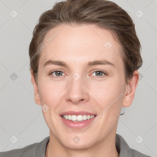 Joyful white young-adult female with short  brown hair and grey eyes