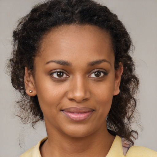 Joyful black young-adult female with medium  brown hair and brown eyes