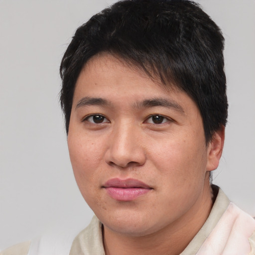 Joyful asian young-adult male with short  black hair and brown eyes