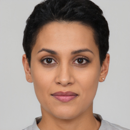 Joyful latino young-adult female with short  black hair and brown eyes