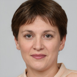 Joyful white adult female with short  brown hair and grey eyes