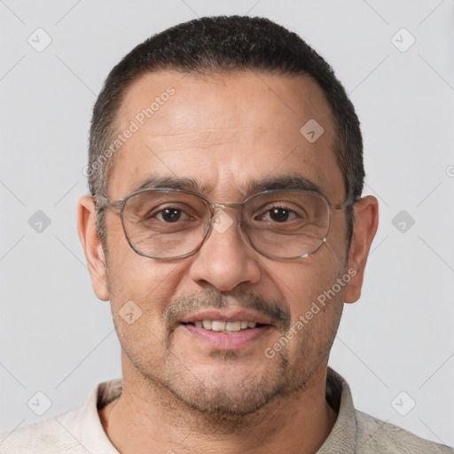 Joyful white adult male with short  brown hair and brown eyes