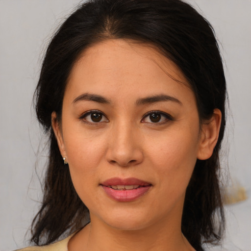 Joyful latino young-adult female with medium  brown hair and brown eyes