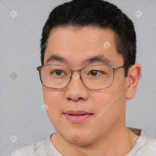 Joyful latino young-adult male with short  black hair and brown eyes