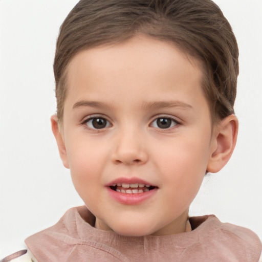 Joyful white child female with short  brown hair and brown eyes