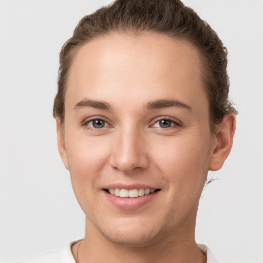 Joyful white young-adult female with short  brown hair and brown eyes