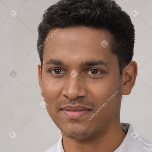 Joyful black young-adult male with short  black hair and brown eyes