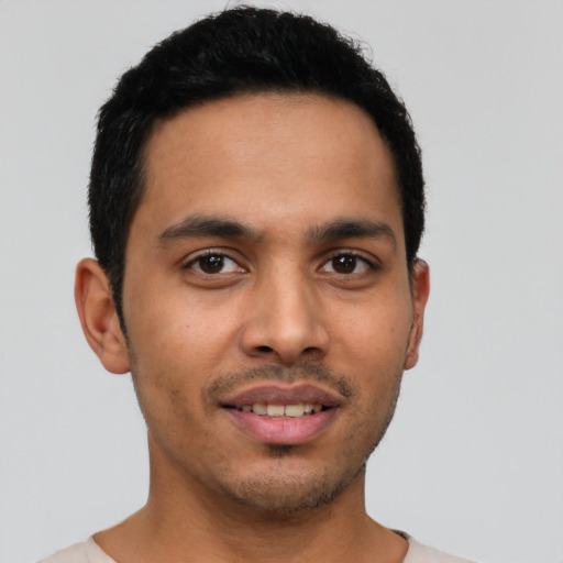 Joyful latino young-adult male with short  black hair and brown eyes