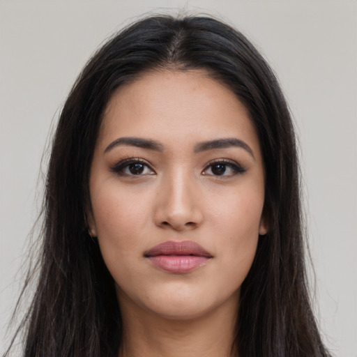 Joyful latino young-adult female with long  brown hair and brown eyes