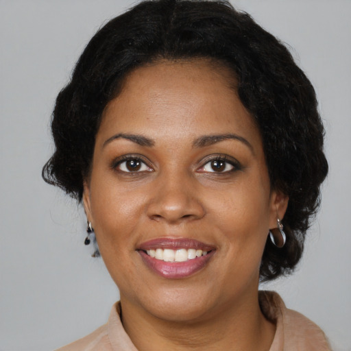 Joyful black young-adult female with medium  brown hair and brown eyes