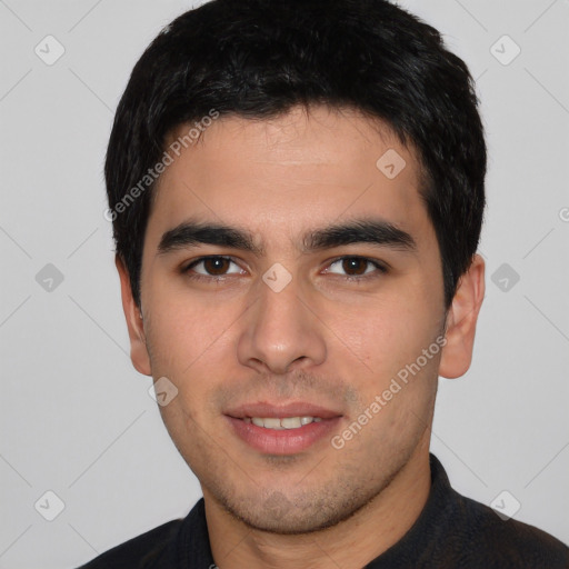 Joyful white young-adult male with short  black hair and brown eyes