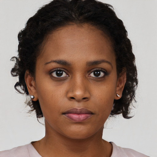 Neutral black young-adult female with medium  brown hair and brown eyes