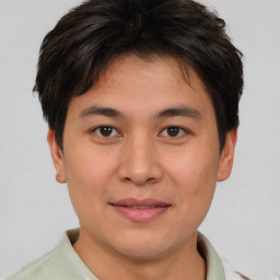 Joyful asian young-adult male with short  brown hair and brown eyes