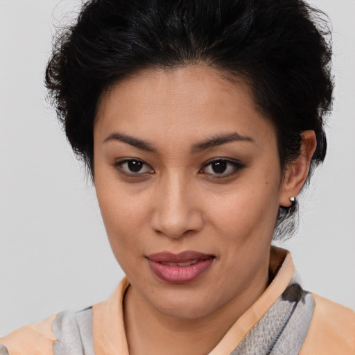 Joyful latino young-adult female with short  brown hair and brown eyes