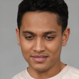 Joyful latino young-adult male with short  brown hair and brown eyes