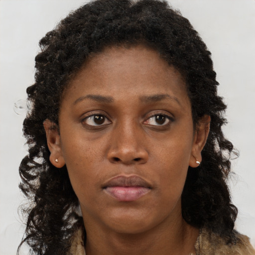 Neutral black young-adult female with long  brown hair and brown eyes