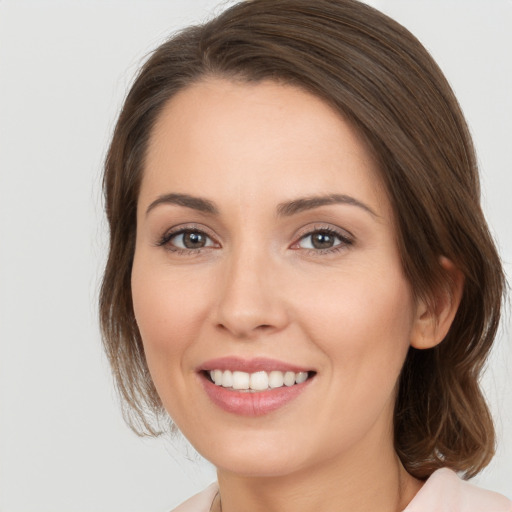 Joyful white young-adult female with long  brown hair and brown eyes