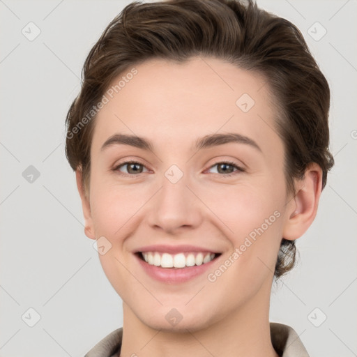 Joyful white young-adult female with short  brown hair and grey eyes