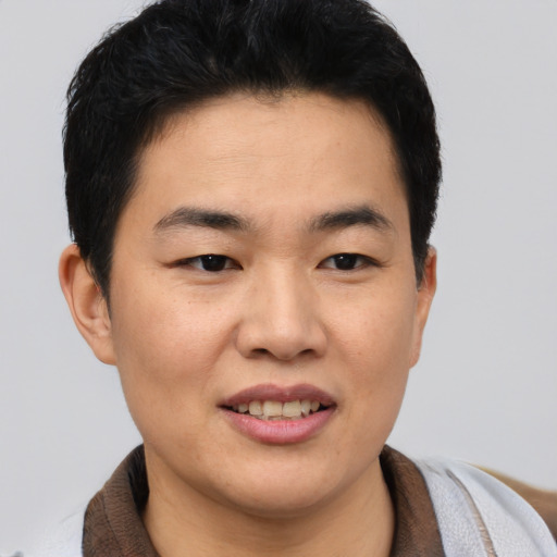 Joyful asian young-adult female with short  brown hair and brown eyes