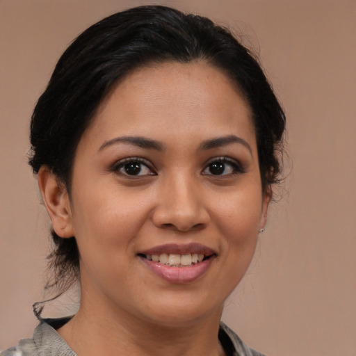 Joyful latino young-adult female with medium  brown hair and brown eyes