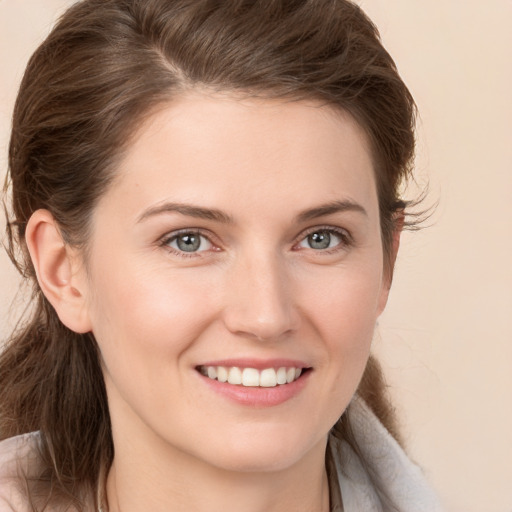 Joyful white young-adult female with medium  brown hair and grey eyes