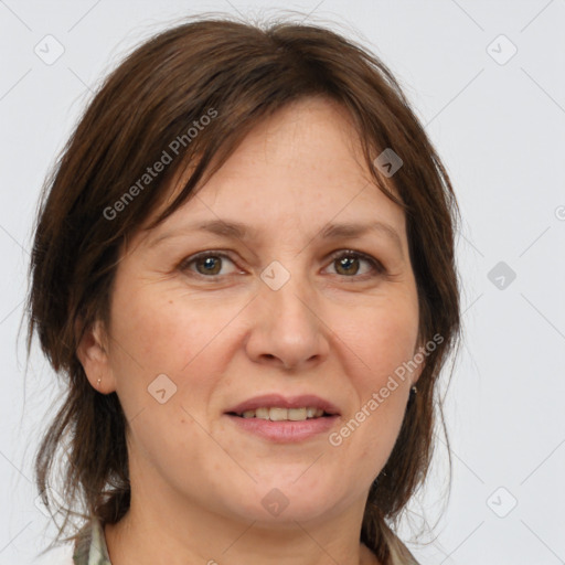 Joyful white adult female with medium  brown hair and grey eyes