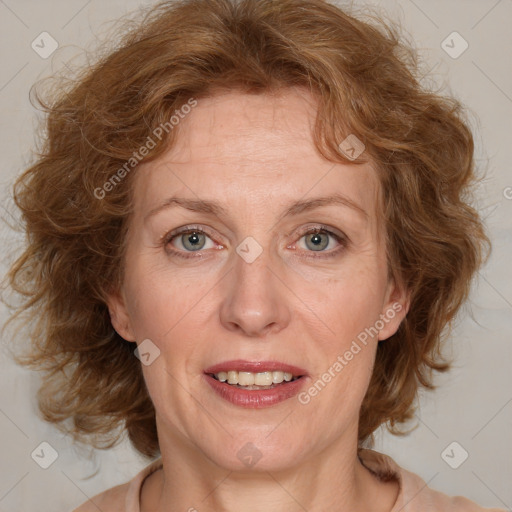 Joyful white adult female with medium  brown hair and blue eyes