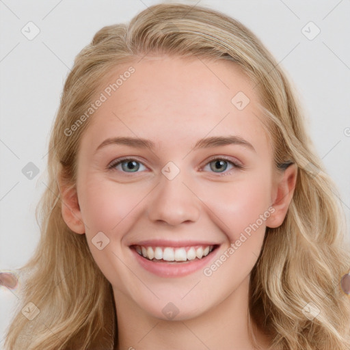 Joyful white young-adult female with long  brown hair and blue eyes