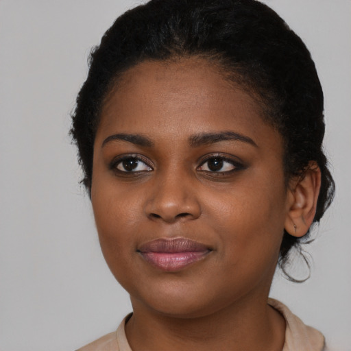 Joyful black young-adult female with medium  brown hair and brown eyes