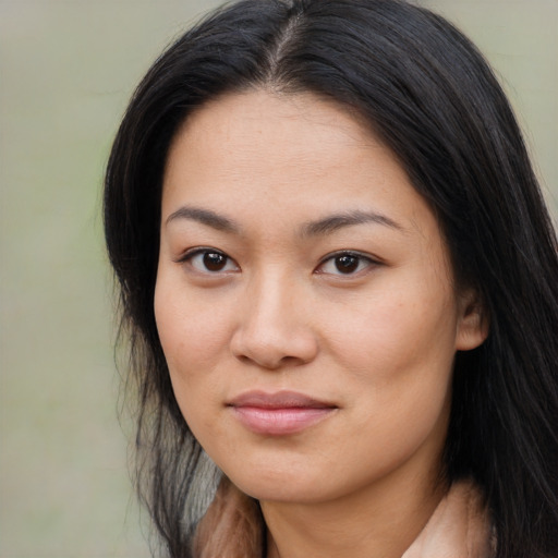 Joyful asian young-adult female with long  brown hair and brown eyes