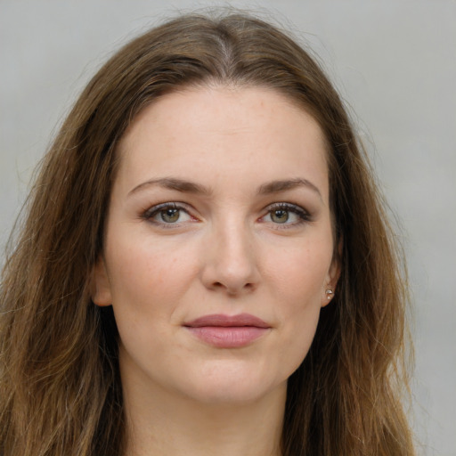 Joyful white young-adult female with long  brown hair and green eyes