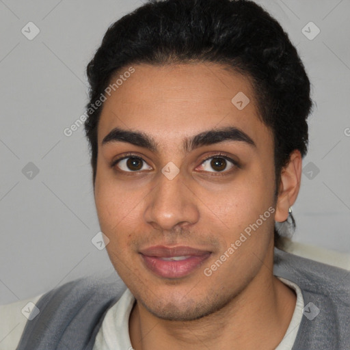 Joyful latino young-adult male with short  black hair and brown eyes