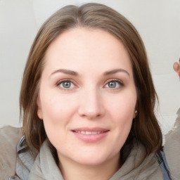 Joyful white young-adult female with medium  brown hair and blue eyes