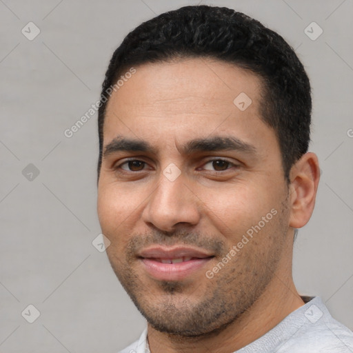 Joyful white young-adult male with short  black hair and brown eyes