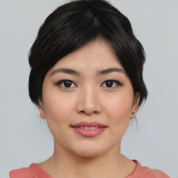 Joyful asian young-adult female with medium  black hair and brown eyes