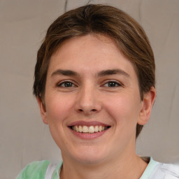 Joyful white young-adult female with medium  brown hair and green eyes