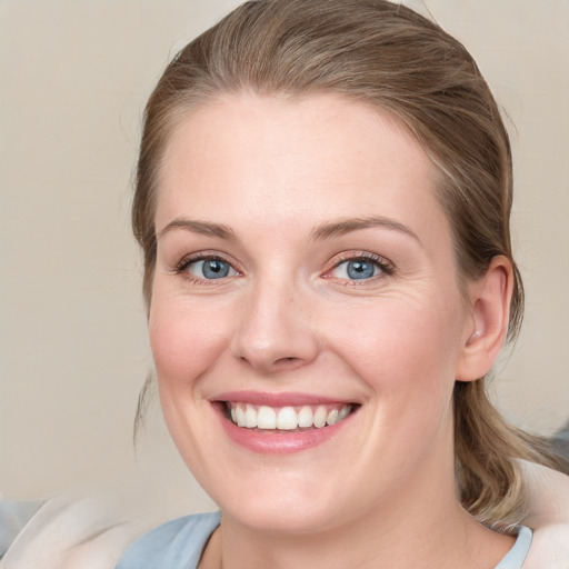 Joyful white young-adult female with medium  brown hair and blue eyes