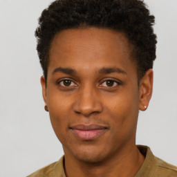 Joyful black young-adult male with short  brown hair and brown eyes