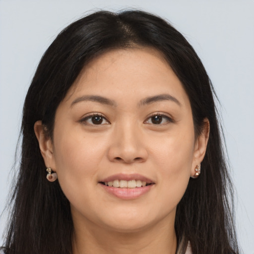 Joyful asian young-adult female with long  brown hair and brown eyes