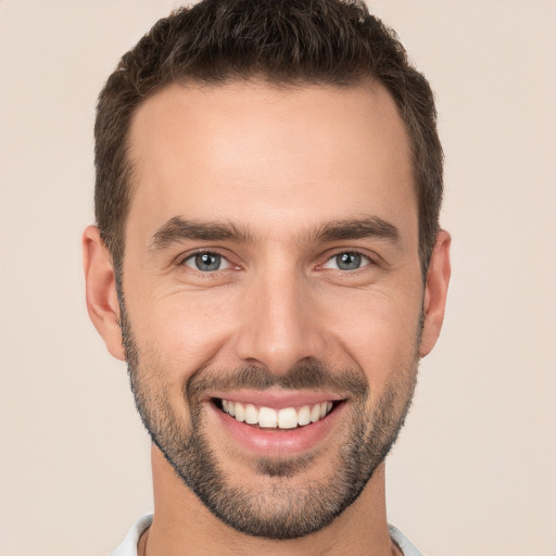 Joyful white young-adult male with short  brown hair and brown eyes