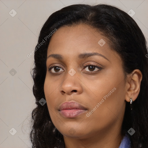 Joyful black young-adult female with long  brown hair and brown eyes